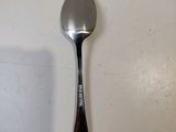 a spoon with a spoon handle on a white surface