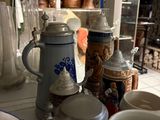 many cups and mugs sitting on the counter