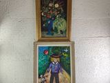 two paintings of a man and a dog on a table