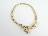 a close up of a gold bracelet with a clasp on a white surface
