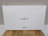 a box of chanel perfume sitting on top of a wooden table