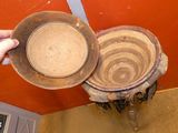 a person holding a bowl and a bowl on a table