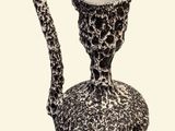 a black and white picture of a vase with a handle