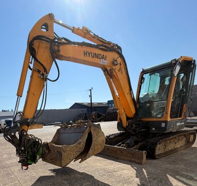 an image of a yellow and black excavator