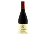 bottle of red wine with a red cap on a white background