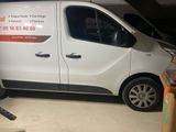 a white van parked in a garage with a sign on the side of the van