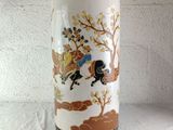 a vase that has a picture of a man riding a horse on it
