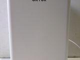 a white refrigerator sitting on a counter next to a white wall