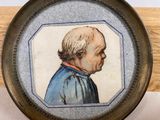 painting of a man in a blue shirt in a wooden frame