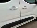 a white van with black trims parked in a parking lot