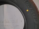 tires are lined up on a wall in a garage