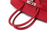 red leather handbag on white background with clipping for strap