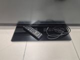 a remote control sitting on top of a glass shelf