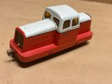 a red and white toy train on a table