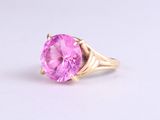 an image of a close up of a pink ring on a white surface