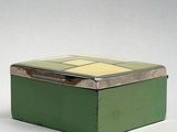 a small green box with a yellow and white design on it