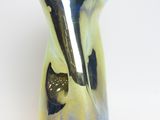 a blue and yellow vase with a black cat on it