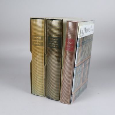 three books are stacked on top of each other on a white surface