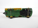 a green and yellow toy train on a white surface