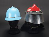 two helmets with helmets on each of them sitting next to each other