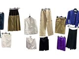 many different types of pants and jackets on a hanger