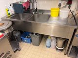 a stainless steel sink in a commercial kitchen