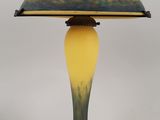 a yellow and black table lamp with a black base