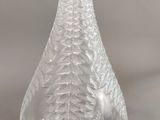 clear glass vase with a leaf design on the bottom