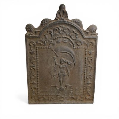 a small cast iron plaque with an image of a man holding a child