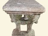 a stone table with a bird on top of it