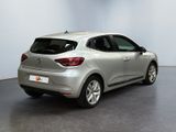 the rear end of a silver car in a white room