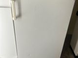 a white stove top oven sitting in the corner of a kitchen