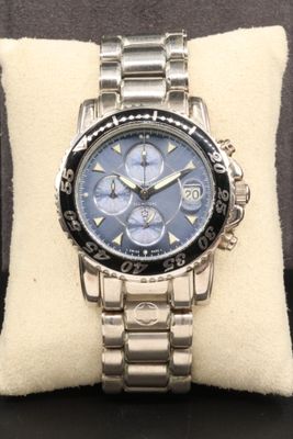 the watch is on a pillow on a black surface