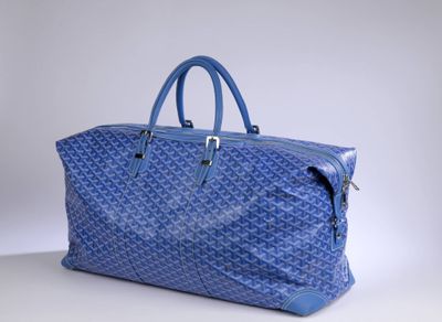 a blue bag sitting on top of a table next to a white wall