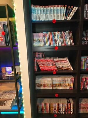 a book shelf with many dvds on it in a room