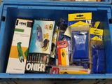 a blue box filled with assorted items on a table