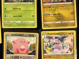 several pokemon cards are displayed on a table in front of a black background