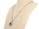 an image of a necklace on a mannequin with a blue stone