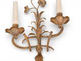 a wall mounted candle holder with two candles on it