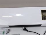 an image of a white air conditioner sitting on top of a table