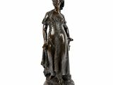 bronze statue of a woman in a dress and hat