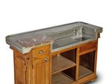 a kitchen island with a sink and a marble counter top