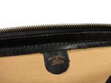 the inside of a black and tan purse with a zipper