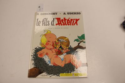 un livre sur lequel figure la photo d'un bébé dans un nid posé sur une table