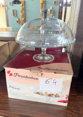 a cake stand with a glass dome on top of it