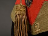 an old military hat with a tassel hanging from it ' s side