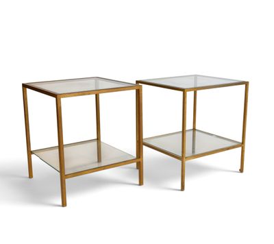 a pair of glass and brass side tables