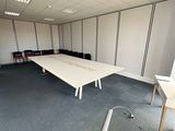a room with a long table and chairs in it