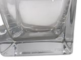 a clear glass vase with a candle inside of it