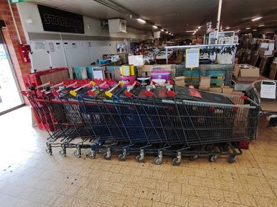 a shopping cart that is sitting in the middle of the floor